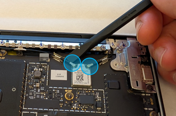 Screenshot that shows disconnecting coax cables from the Surface Laptop with a nylon spudger