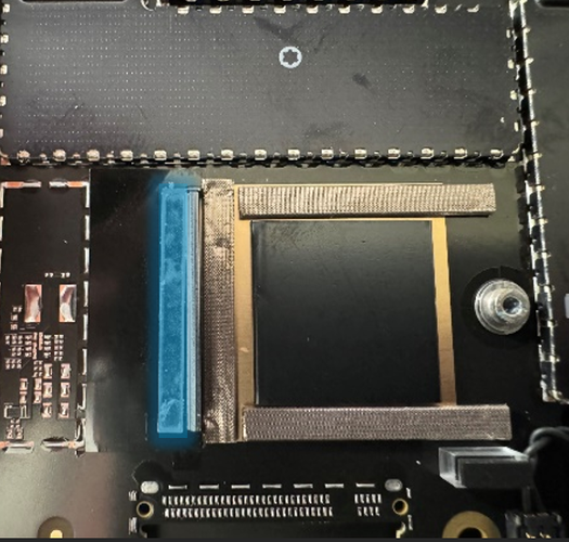 Screenshot that shows placing a spacer on top of the black tape aligned with the SSD connector flange.
