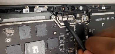 Screenshot that shows nylon spudger disconnecting one of three camera FPCs from motherboard.