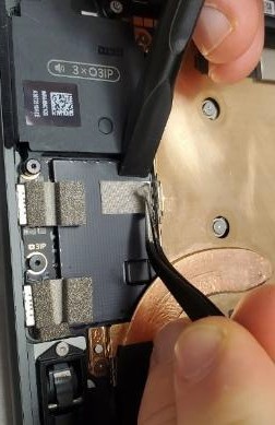 Screenshot that shows lifting shielding tape beneath left speaker while holding shield down to avoid detachment.