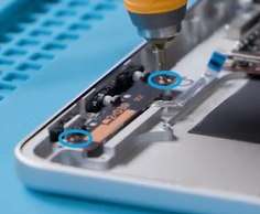 Screenshot that shows the button switch board and FPC being lifted out of the enclosure after removing the securing screws.