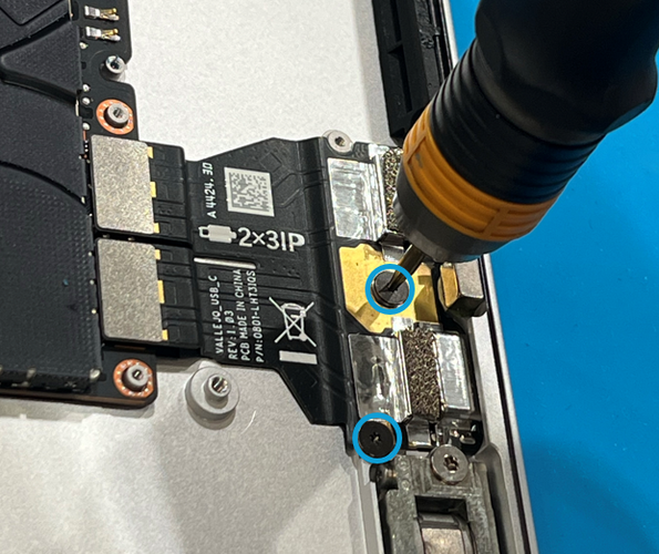 Photo that shows removing a USB-C FPC screw with a 3IP screwdriver inside the enclosure.