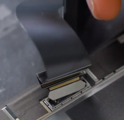 Screenshot that shows lifting the display connector shield with a finger to expose the FPC.