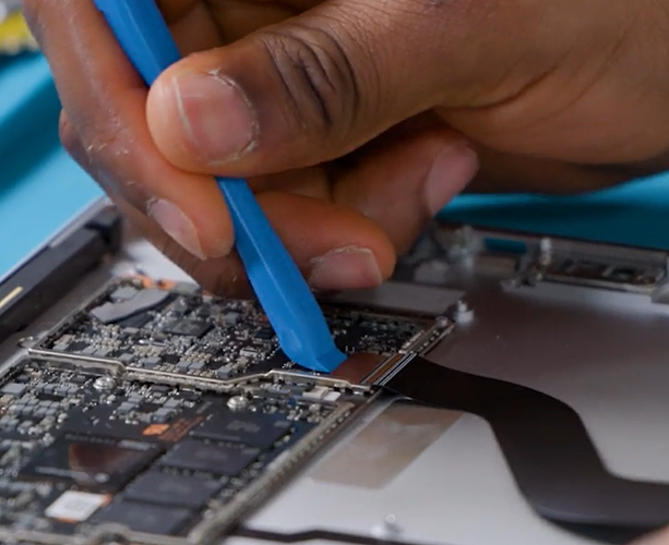 Screenshot that shows using an opening pick to separate remaining adhesive from the display edge.