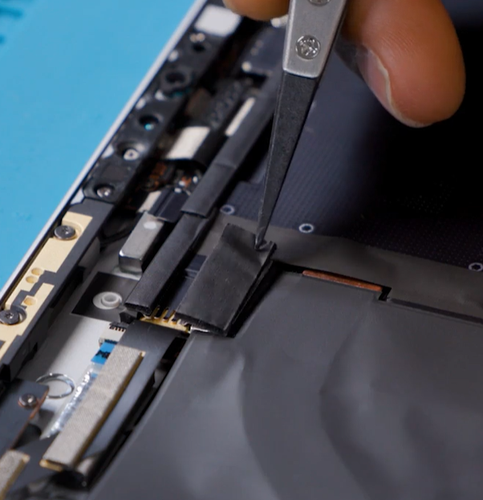 Screenshot that shows reattaching the T2 shield lid over the motherboard area during reassembly.