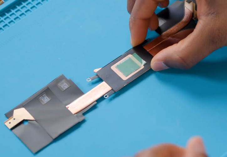 A person holding a small chip.