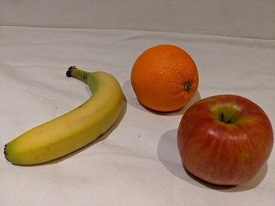 Photograph of an apple, a banana, and an orange.