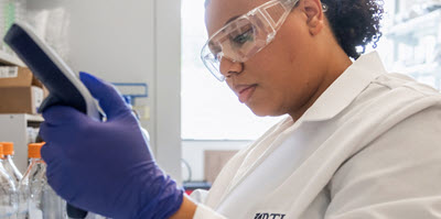 Screenshot of a woman working in an RTI lab.