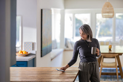 Screenshot of a Woman looking at her mobile device.